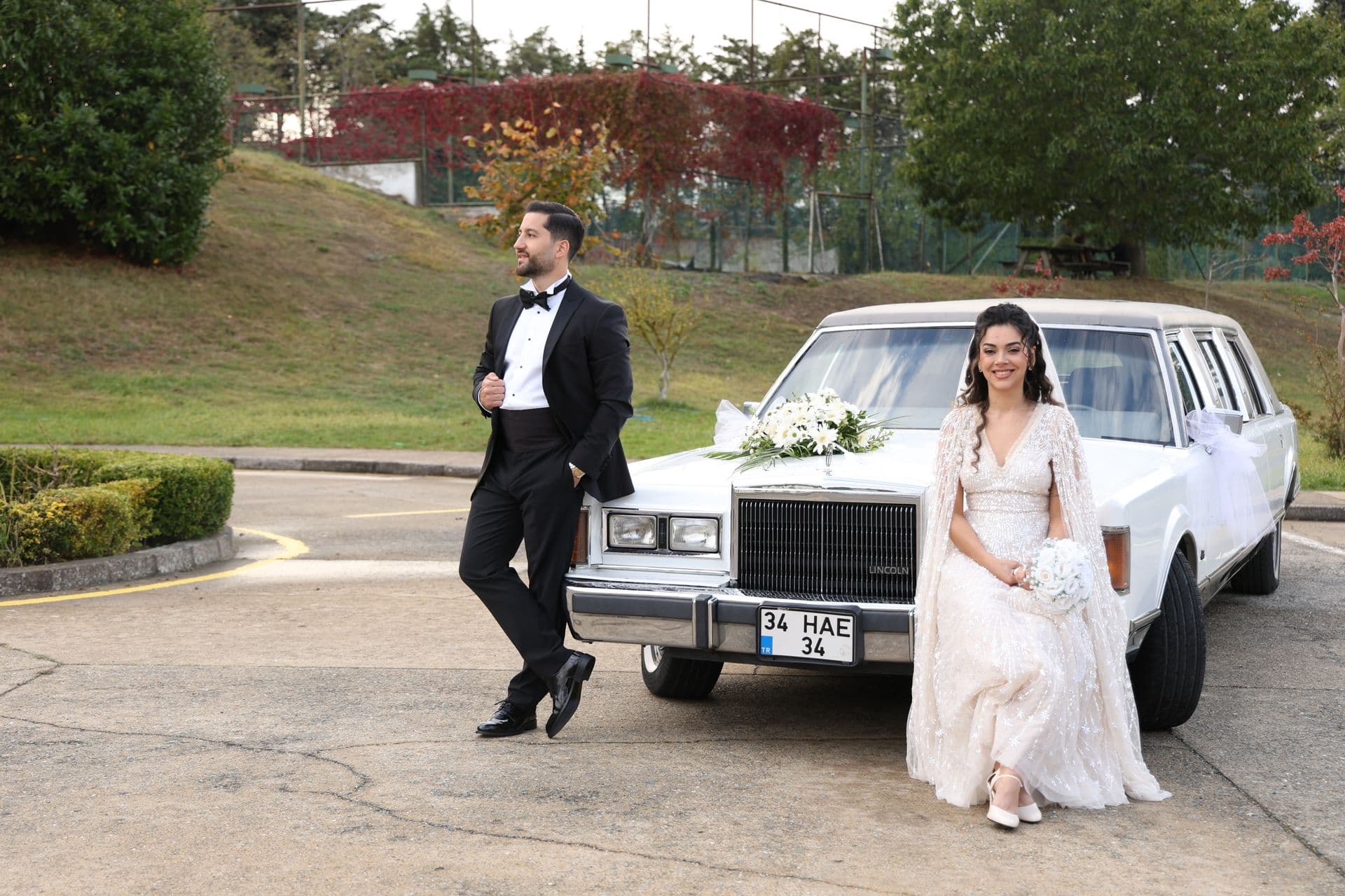 Bride and groom beside vintage wedding sedan, ABIA wedding industry awards context