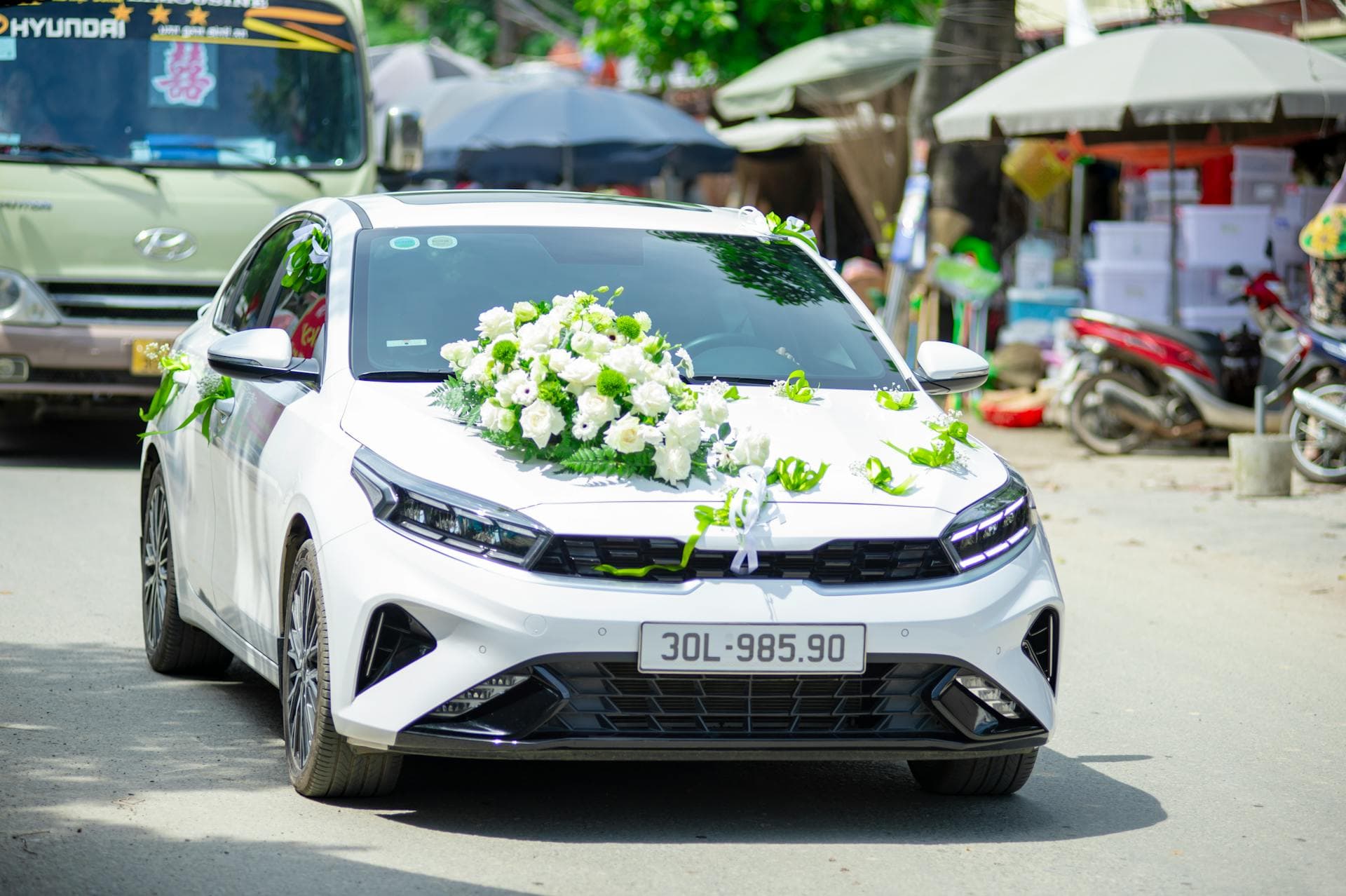 Beautifully decorated wedding car with white flowers, Adelaide wedding car hire pricing guide