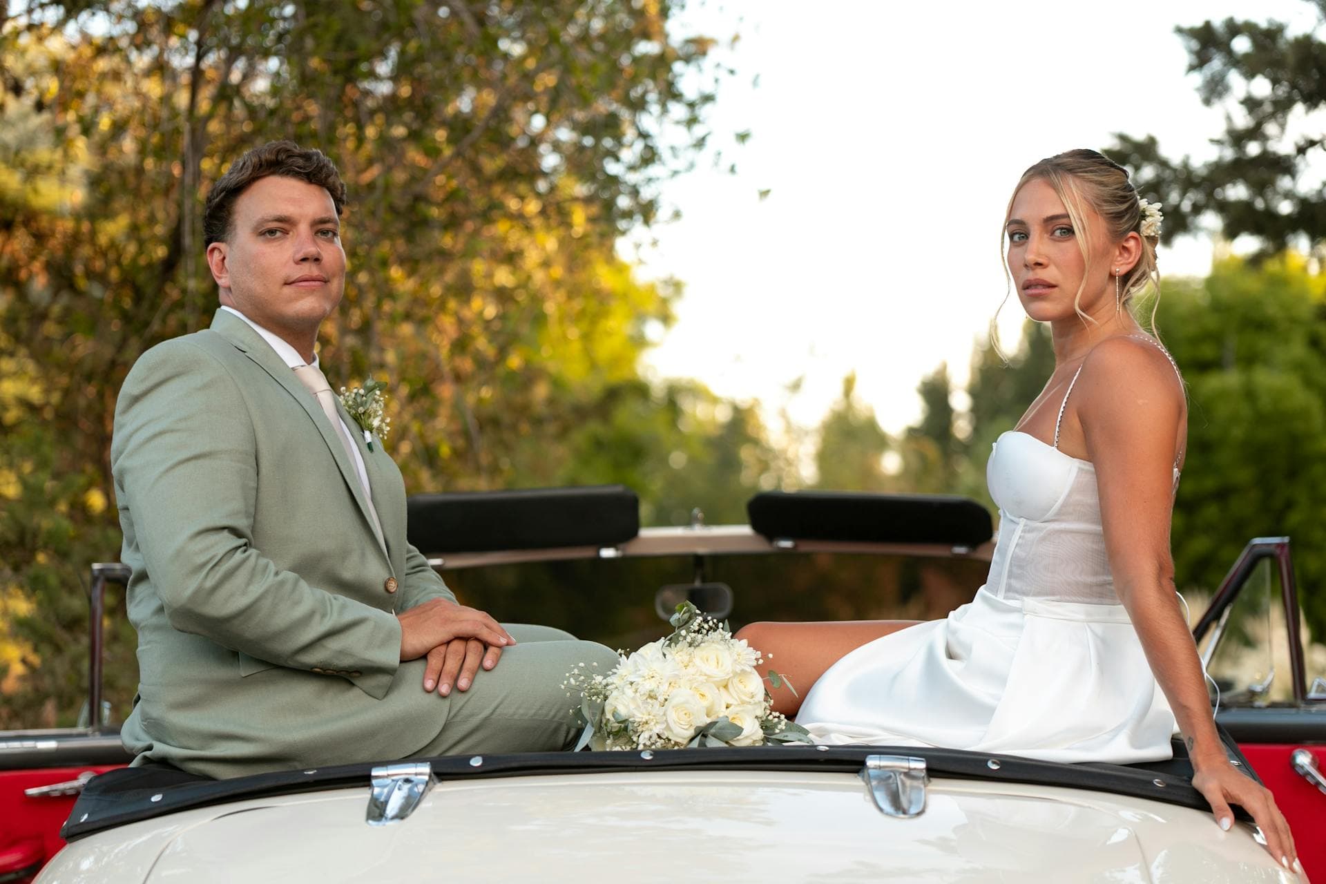 Bride and groom seated on a classic vintage wedding car, Adelaide bridal transport