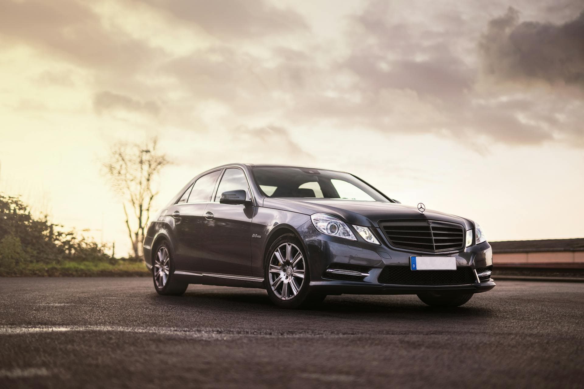 Black sedan at sunset with dramatic cloudscape, Limo Hire Adelaide journal