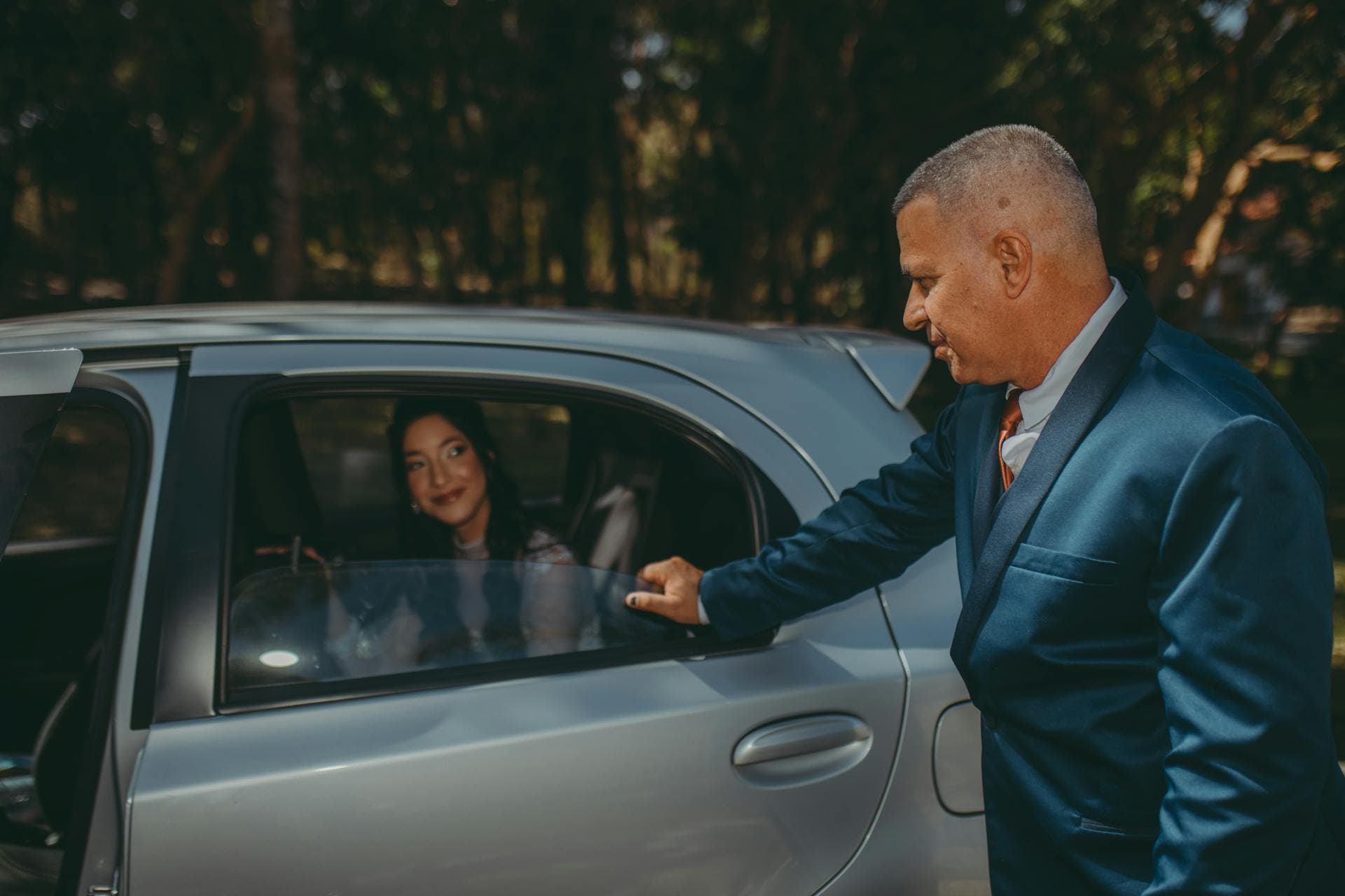 Chauffeur opening rear passenger door of luxury sedan, Adelaide limo hire FAQ