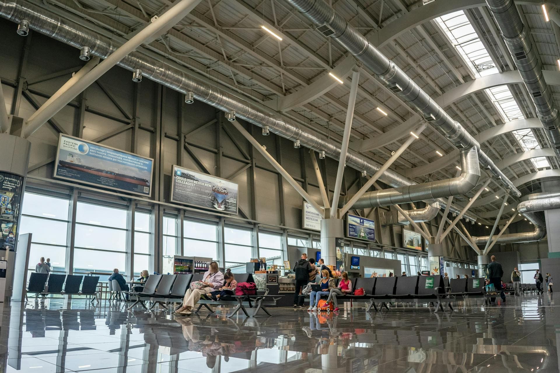 Modern airport terminal interior with seated passengers, Adelaide chauffeured airport transfer service